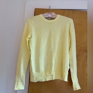 Light yellow Zara knit long-sleeved top with gold buttons at the wrist
